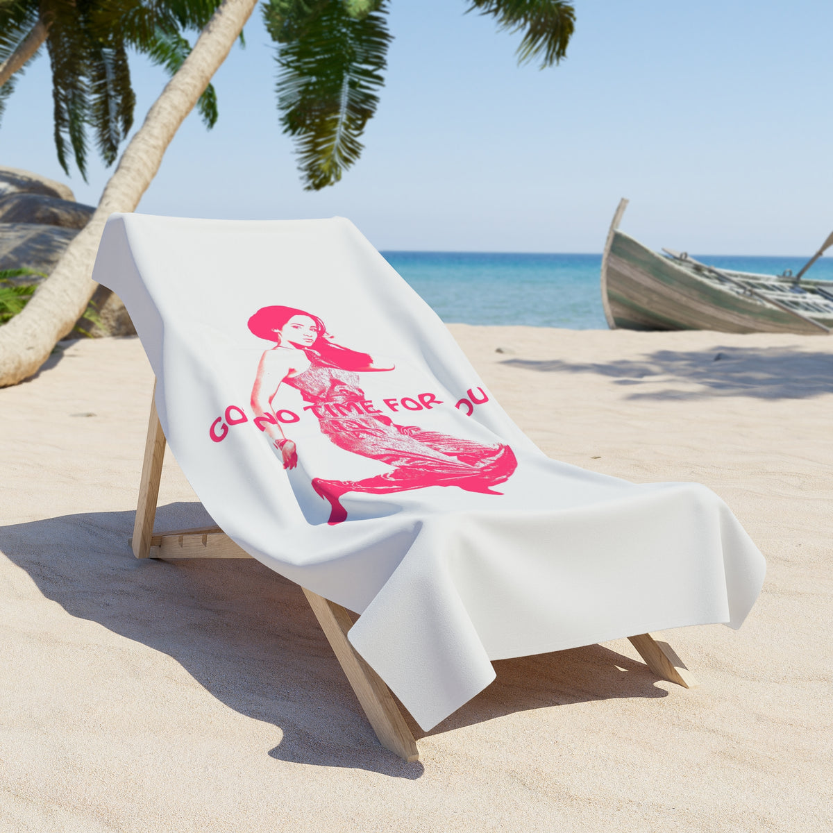 A scene on the beach with a towel over a chair with the image of a young woman with the words Got No Time For You in pink