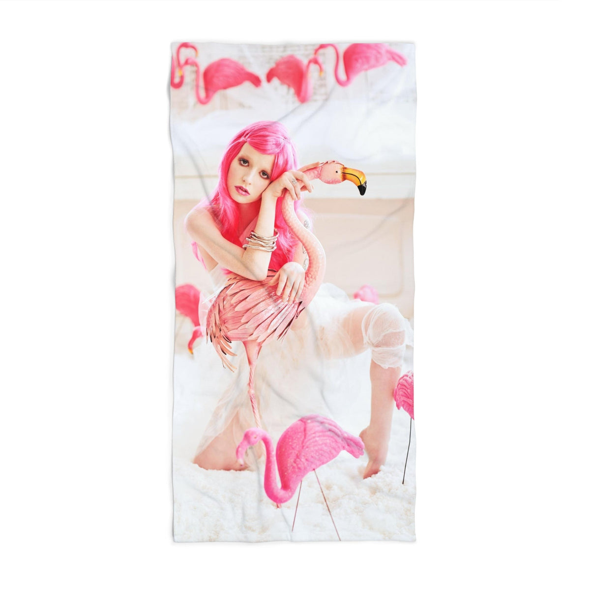 A beach towel with a girl in a pink wig with pink flamingos