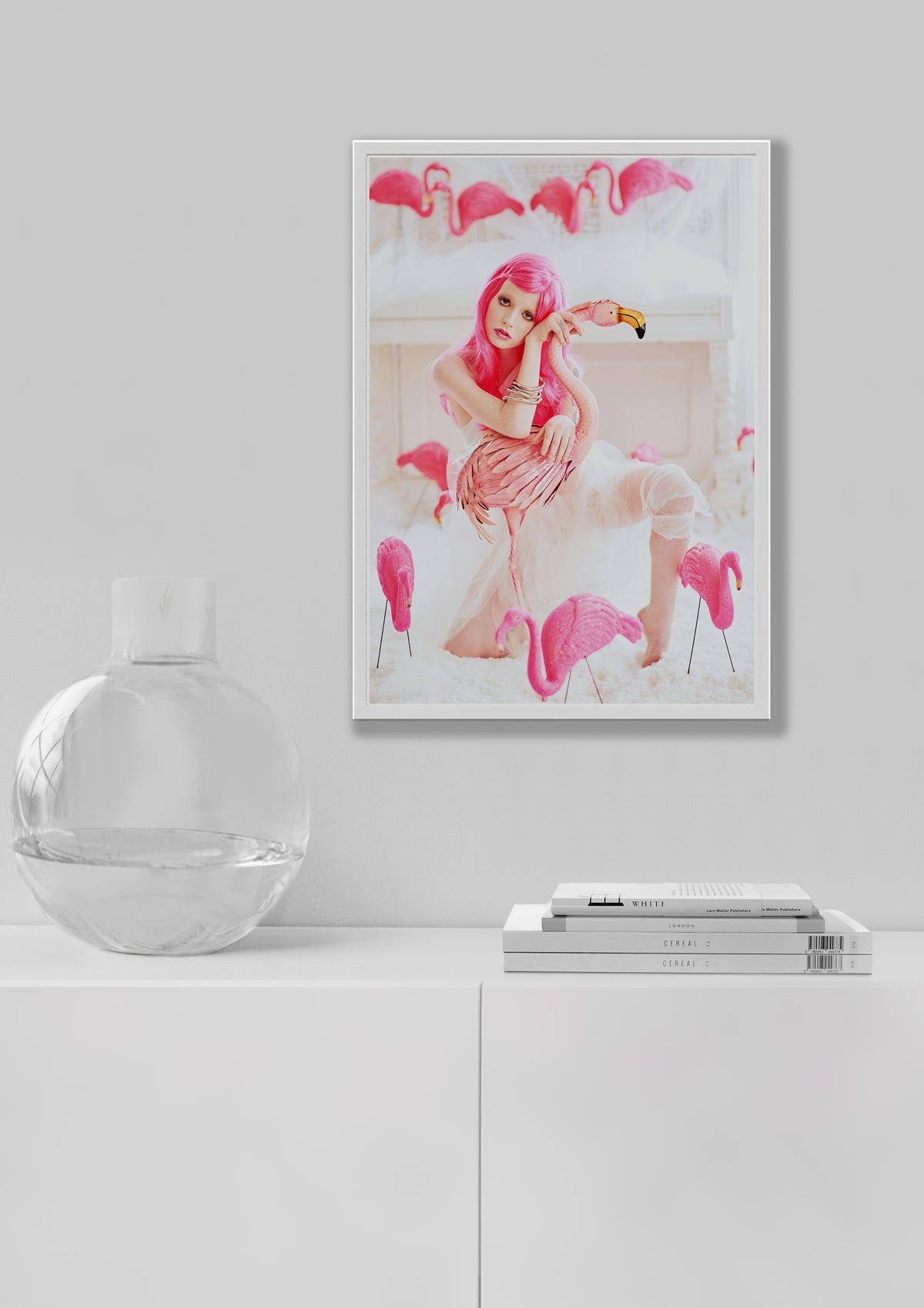 living room view of a framed print of a girl in a pink wig with pink flamingos