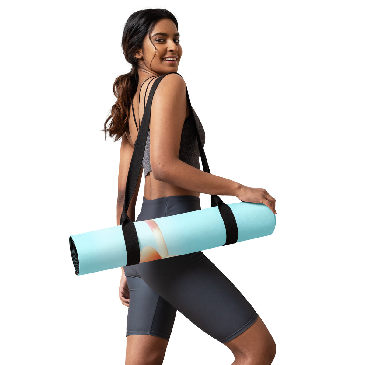 side view of a girl holding a yoga mat