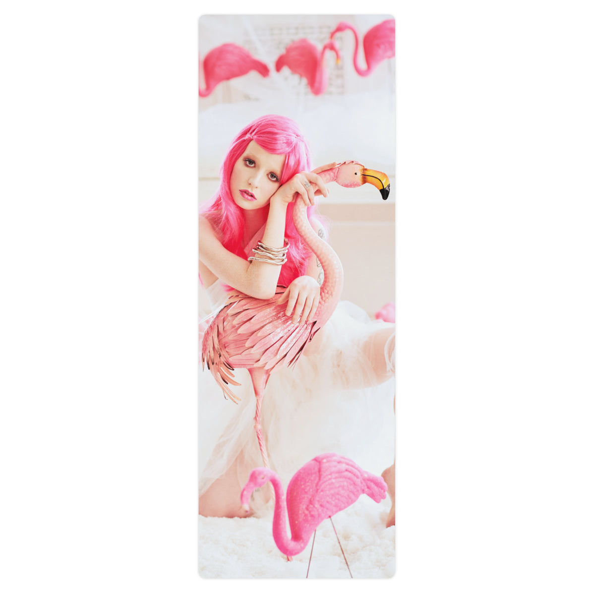 top view of a yoga mat with with a girl in a pink wig with pink flamingos