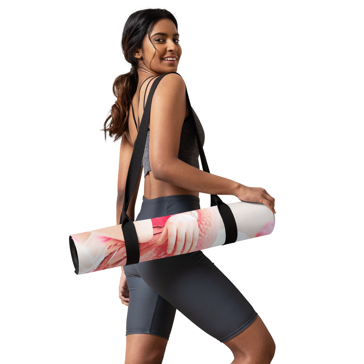 a sporty girl holding a rolled up yoga mat of a girl in a pink wig with pink flamingos