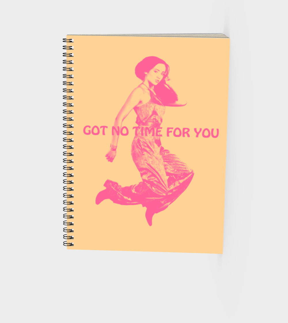 spiral bound journal in muted yellow with a young woman jumping in the air with the words Got NO Time For You both the woman and words are pink